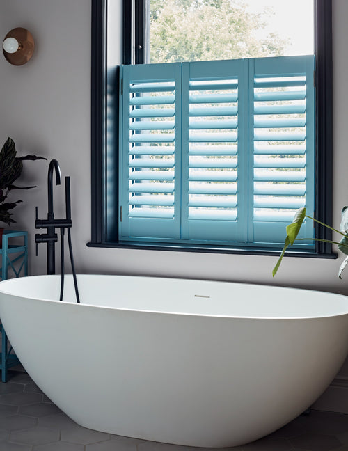 Café style plantation shutters in a living room window