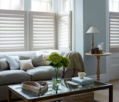 White café style shutters for lower half window coverage